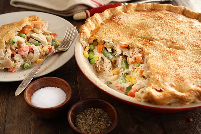Alfredo Chicken Pot Pie with serving on side with salt and pepper dishes