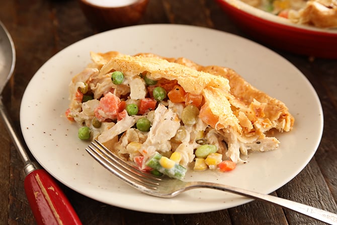 Alfredo Chicken Pot Pie served on white plate with serving spoon on the side