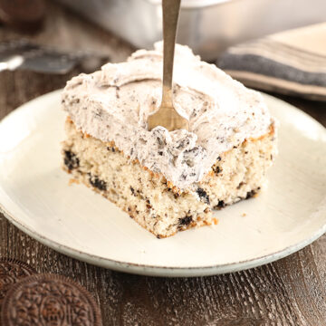 Cookies and Cream Sheet Cake slice with cookies beside plate