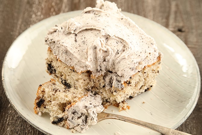 Slice of Cookie and Cream Sheet Cake on plate with serving on the for