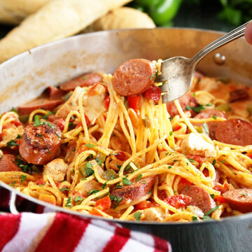 Creamy One Pot Jambalaya in pot being served with fork