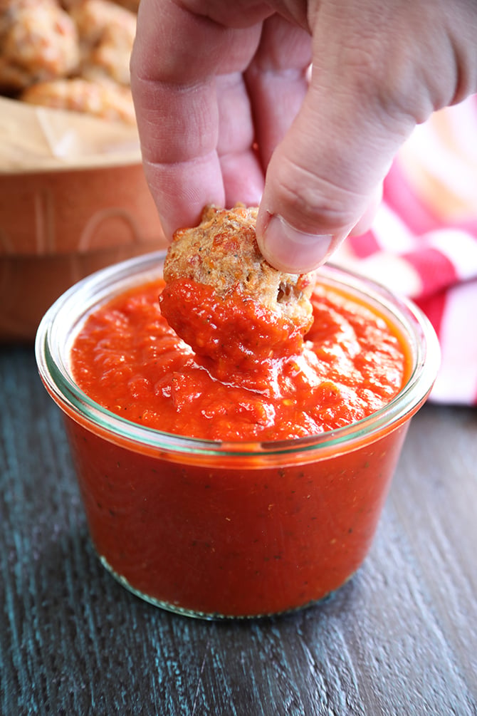 Pizza Sausage Balls while dipping in sauce