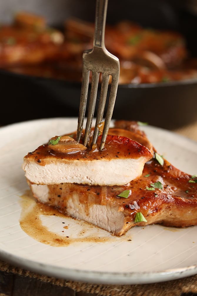 Skillet chops with French onion Gravy served and sliced on plate