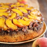Peach Upside Down Cake with fresh peaches in background close photo