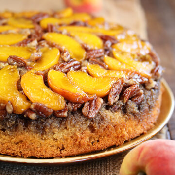 Peach Upside Down Cake with fresh peaches in background close photo