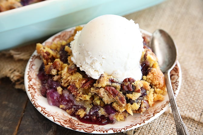 Pineapple Blueberry Dump Cake served on plate with ice cream on top