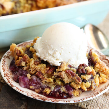 Pineapple Blueberry Dump Cake Served in dish with ice cream on top