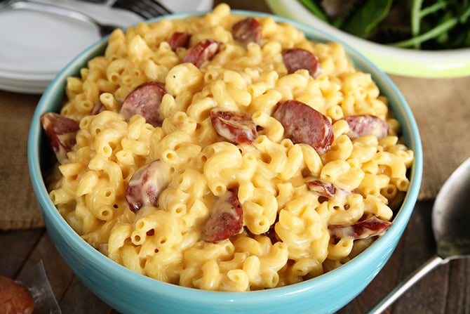 Creamy Smoked Sausage Mac and Cheese in blue serving bowl