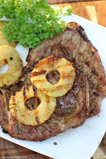Grilled pork chop with slices of pineapple on top