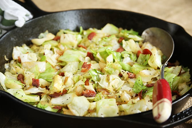 Southern fried cabbage with spoon in skillet