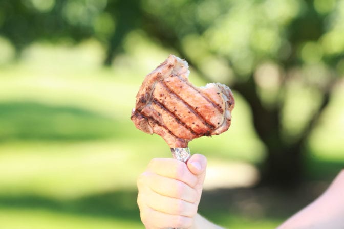 Grilled pork chop on fork