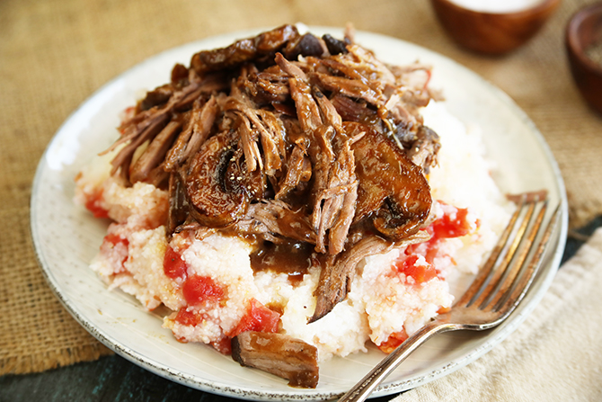 Slow cooker pot roast served over tomato grits