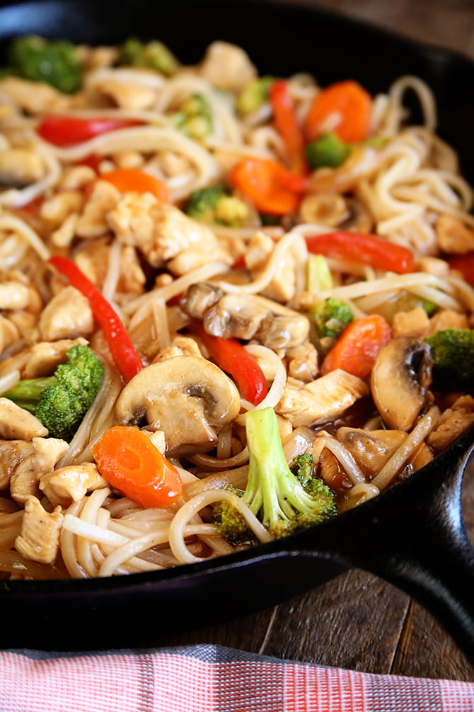 Easy chicken Noodle Stir Fry served in cast iron skillet close up.