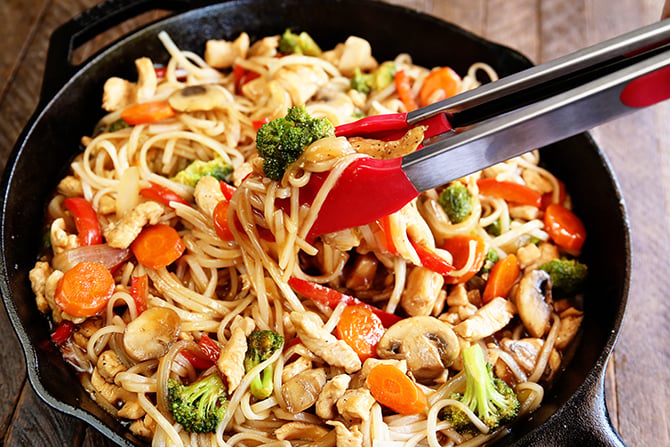 Easy Chicken Noodle Stir Fry being served from cast iron skilet