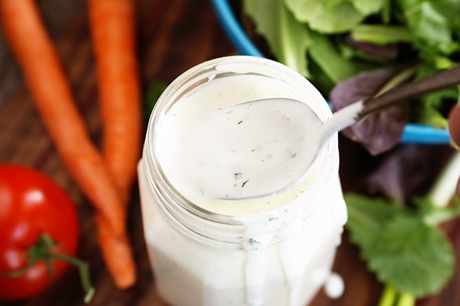 Best Ranch Dressing in jar surrounded by fresh vegetables
