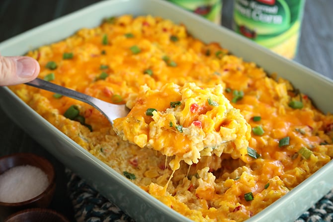 Ultimate Cheesy Corn and Rice Casserole being spooned