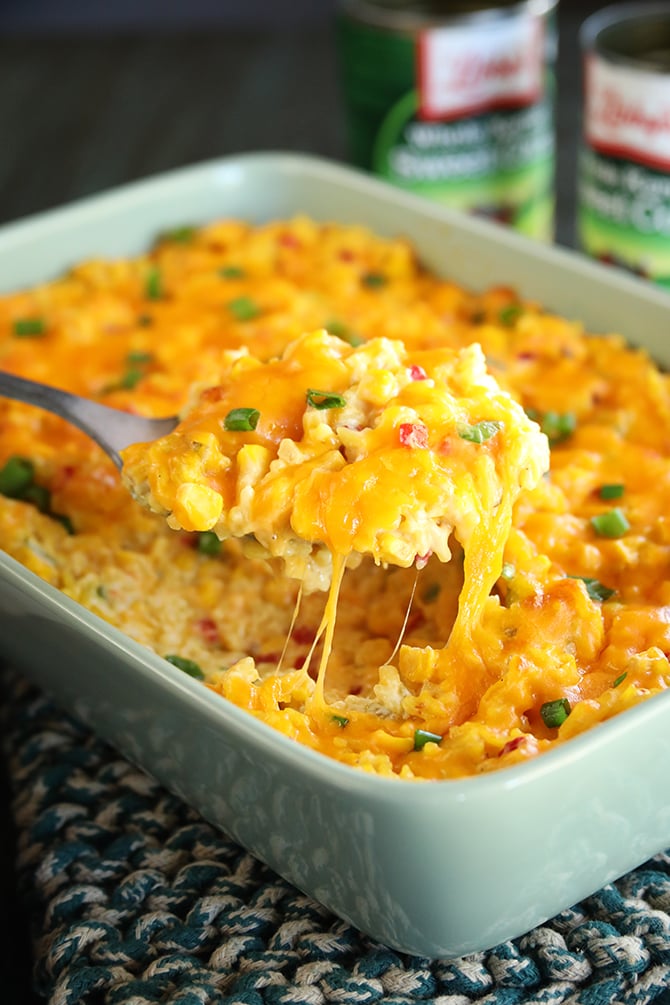 Ultimate Cheesy Corn and Rice Casserole being served with spoon