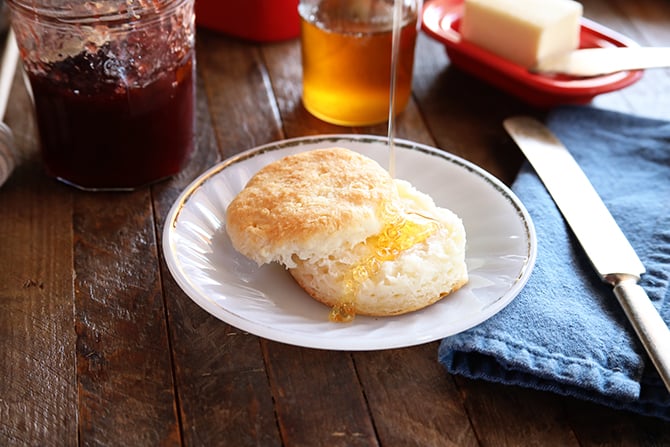 Sliced Buttermilk Biscuits with honey being poured over