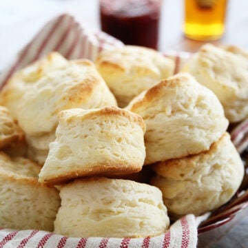 Easy Buttermilk Biscuits stacked in a basket