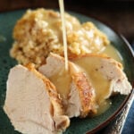Slices of Turkey and Dressing with Turkey Gravy being poured over