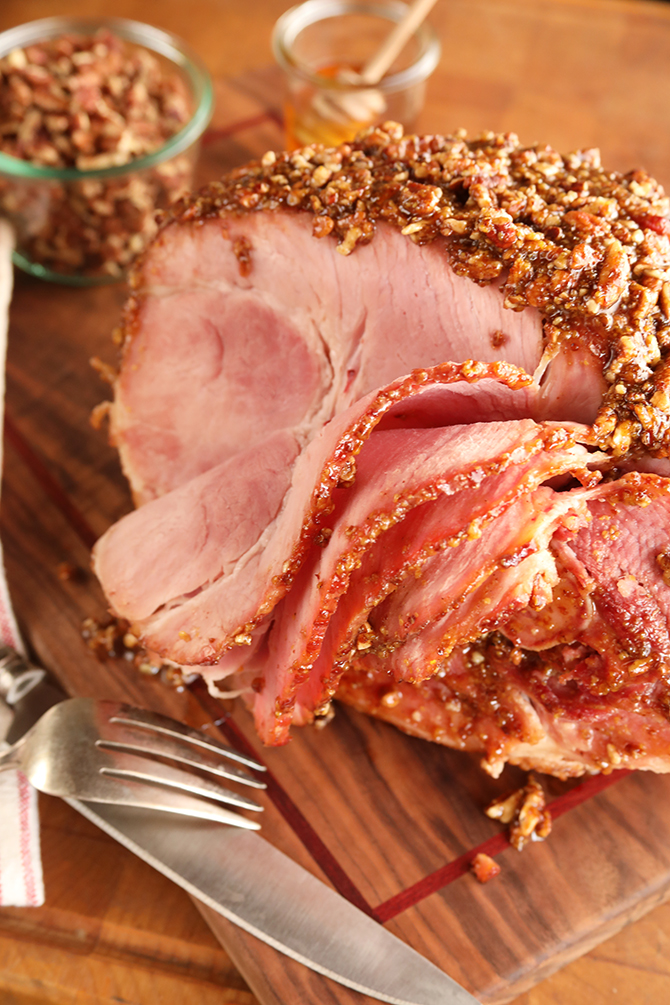Baked ham topped with glaze and pecans