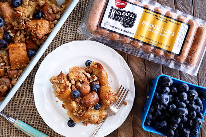Bowl of French Toast and Sausage casserole in serving bowl with blue berries and package of sausage on side