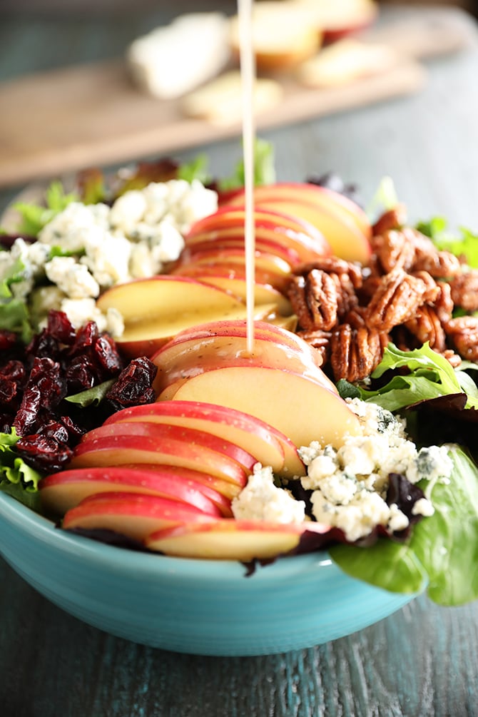 Pouring dressing on Apple salad