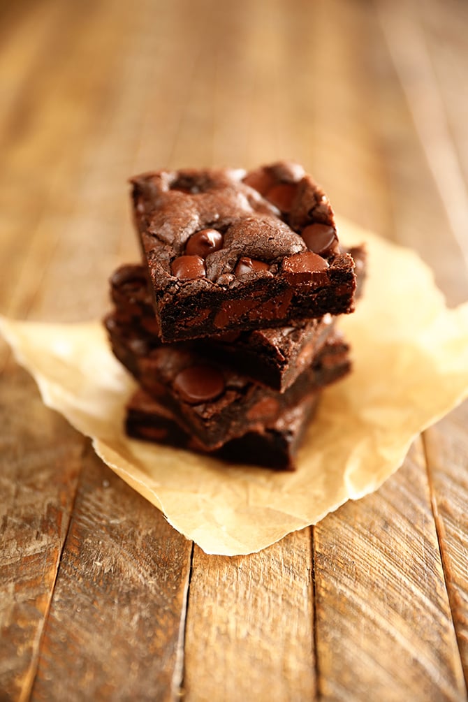 Stacked brownies on parchment paper