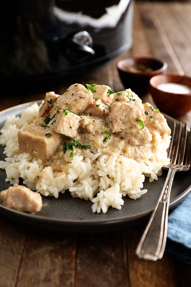 Pork tips over rice with fork