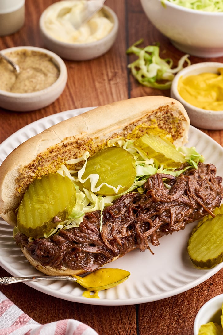 Slow Cooker Roast Beef Debris Po Boys on a plate.