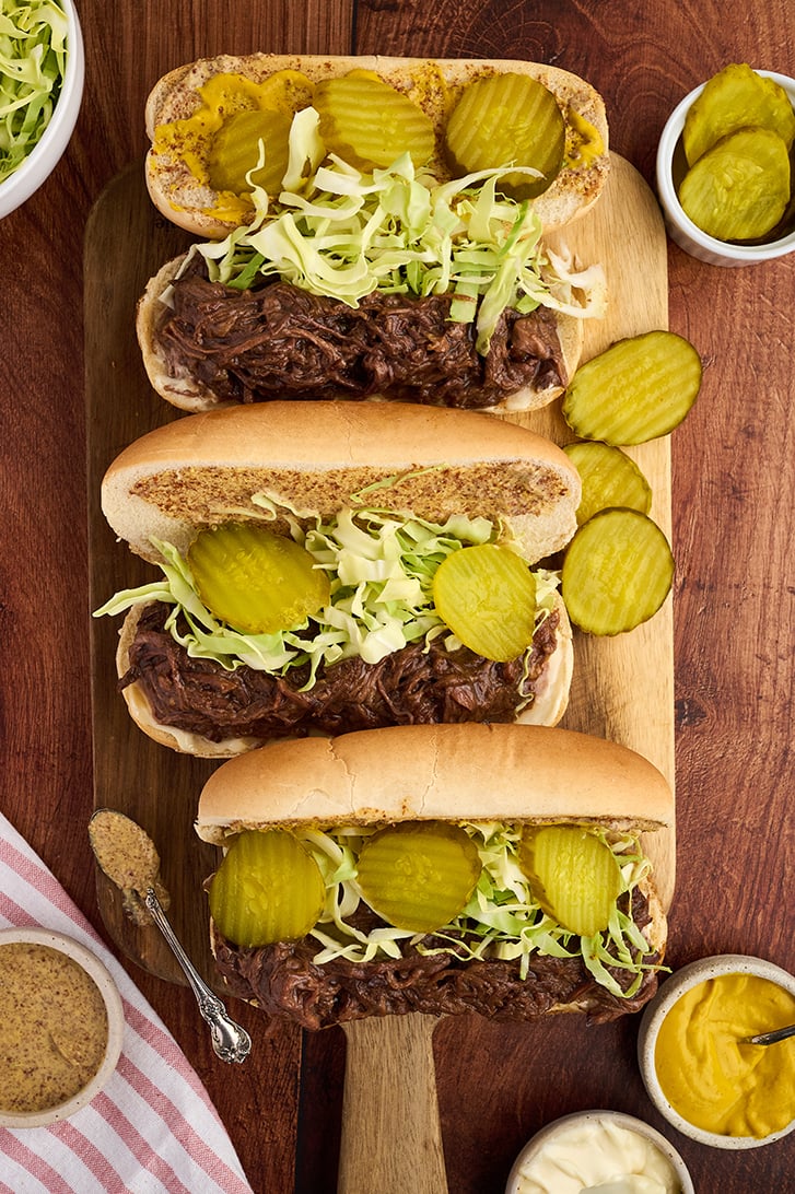 3 Slow Cooker Roast Beef Debris Po Boys on a board.
