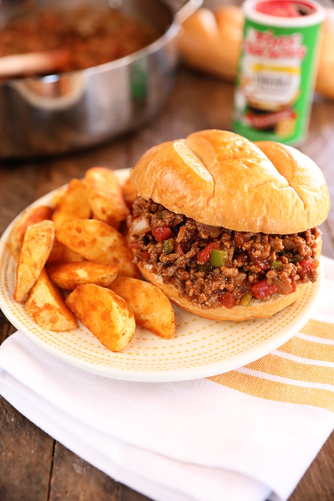 Creole Sloppy Joes on a white plate with potato wedges