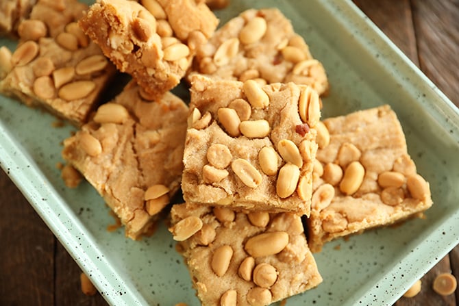 Chewy peanut Butter Cookie bars stacked on green tray