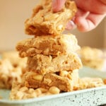 Hand grabbing a Chewy Peanut Butter Cookie Bar from a stack