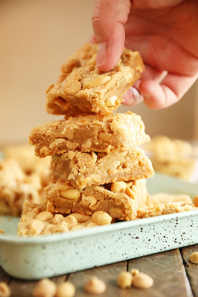 Hand grabbing a Chewy Peanut Butter Cookie Bar from a stack