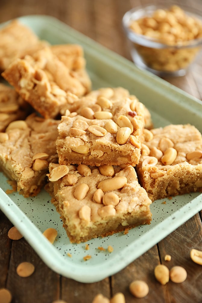 Chewy peanut Butter Cookie bars stacked on green tray
