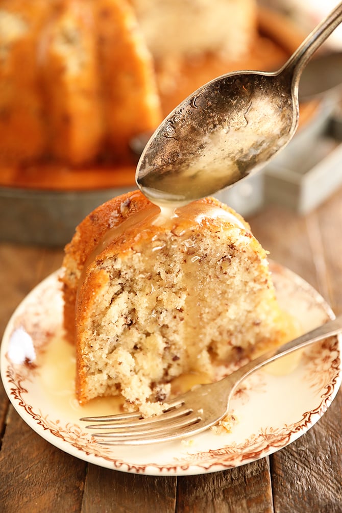 Drizzling butter sauce over a slice of Bama Butter Cake