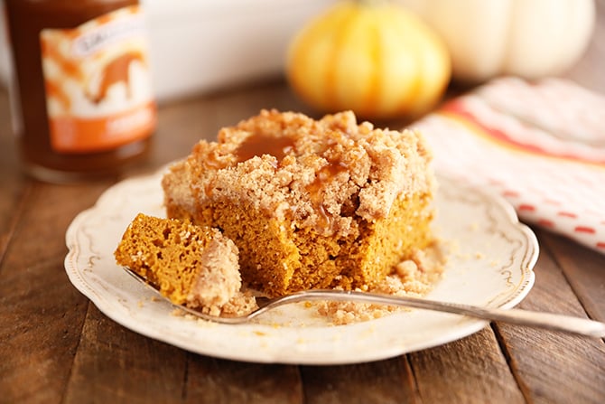 Bite taken out of piece of Carmel Pumpkin Crumb Cake