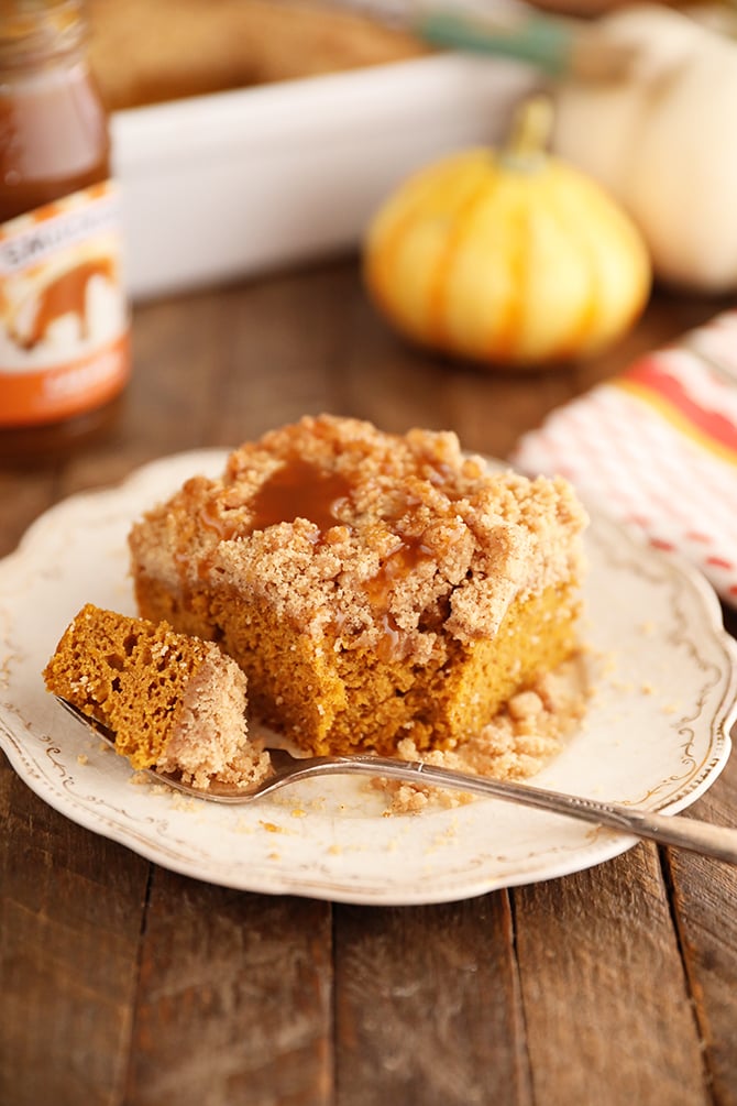 Bite taken out of piece of Carmel Pumpkin Crumb Cake