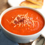 Tomato Soup topped with Bacon and cheese