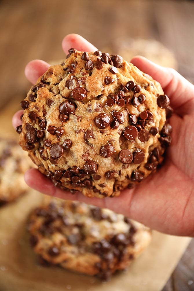 large chocolate chip cookie in hand