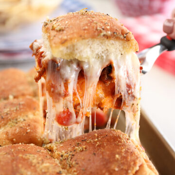 Cheese pull remvoing some Easy Pizza Sloppy Joe Sliders