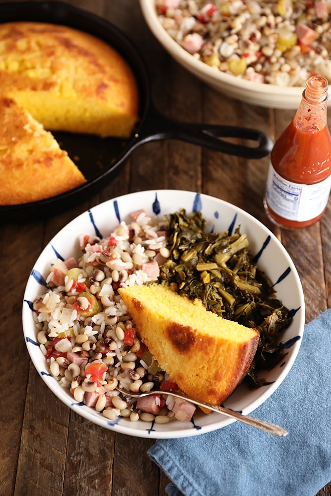 Bolw of Hoppin John, collards, and cornbread