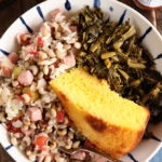 Bolw of Hoppin John, collards, and cornbread