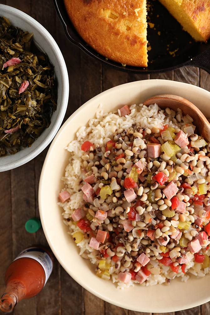 Bowl of Hoppin' John, bowl of collard, pan of cornbread