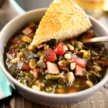 Bowl of Collard Green Soup with Ham and Beans with Cornbread