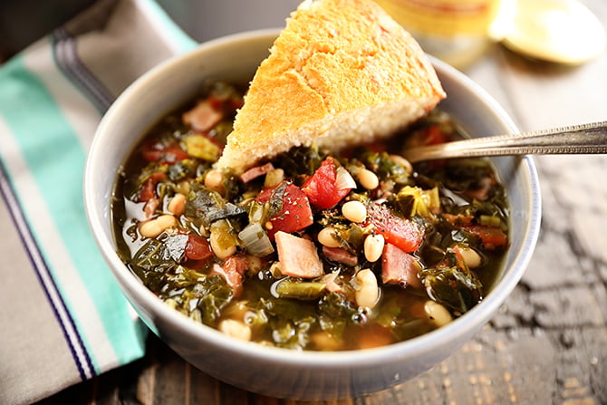 Bowl of Collard Green Soup with Ham and Beans with Cornbread