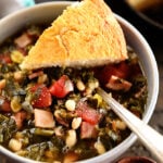 Bowl of Collard Green Soup with Ham and Beans with cornbread