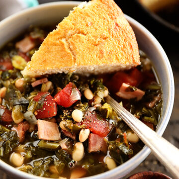 Bowl of Collard Green Soup with Ham and Beans with cornbread