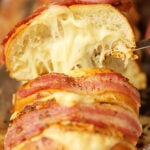 Slice of Cheesy Swiss Bacon Ranch Bread with cheese pull